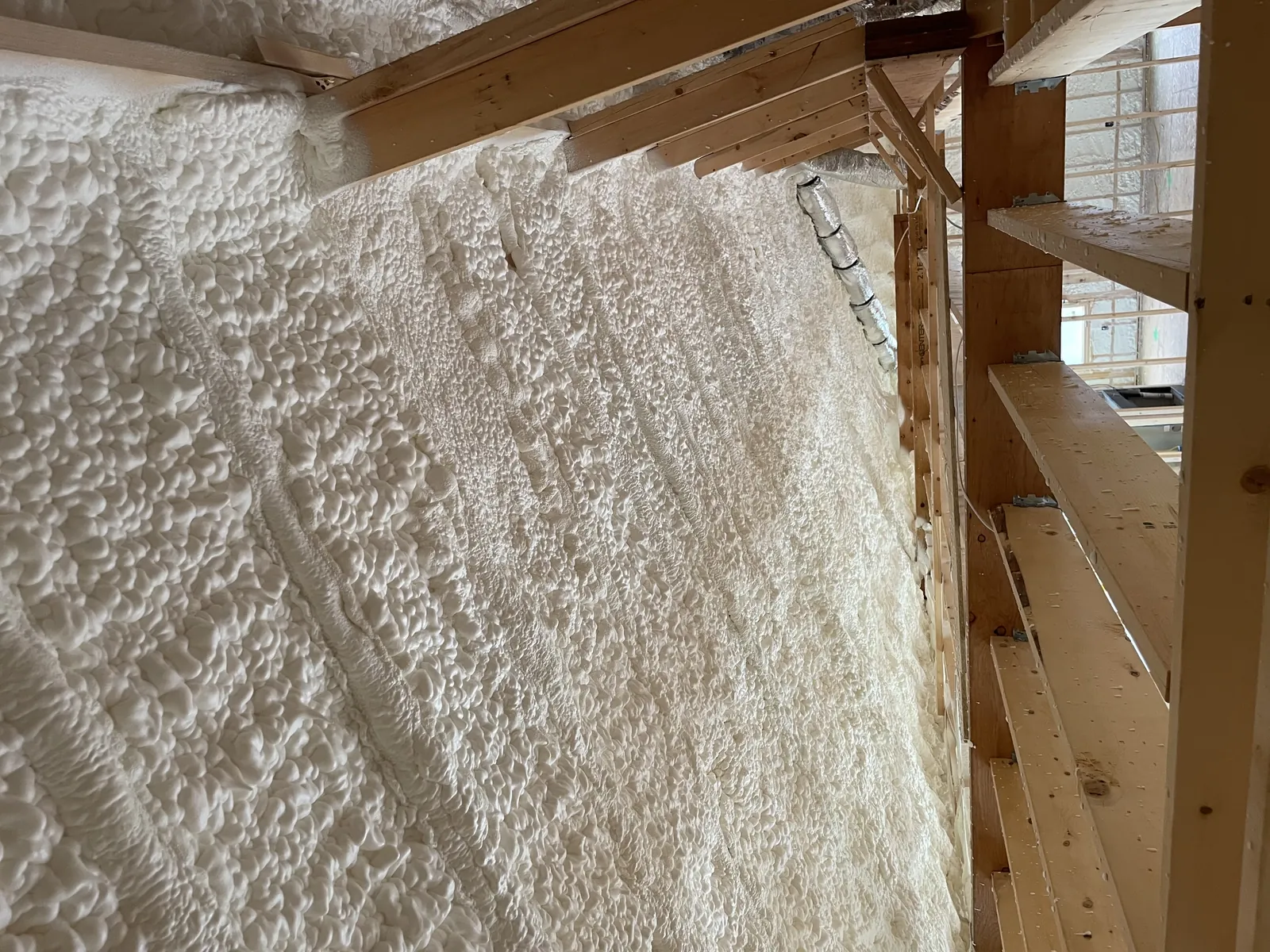 Spray foam applied to the underside of the attic rafters and roof deck